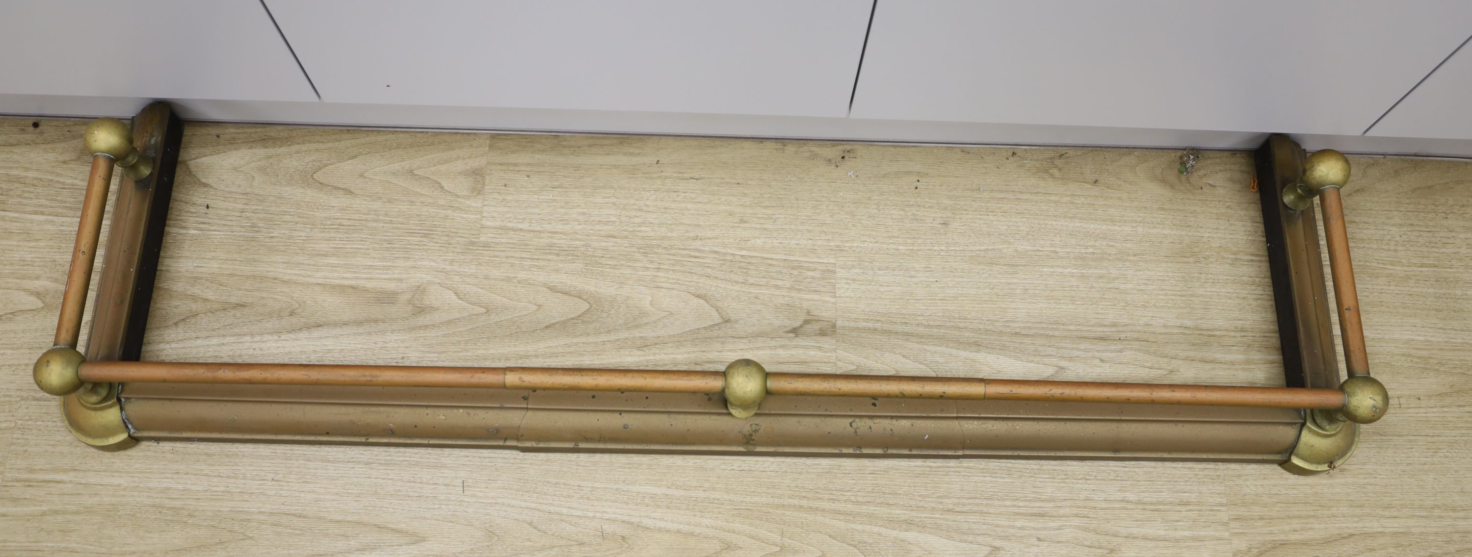 A brass fire fender, length 127cm